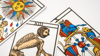 Tarot cards for divination with death on white table